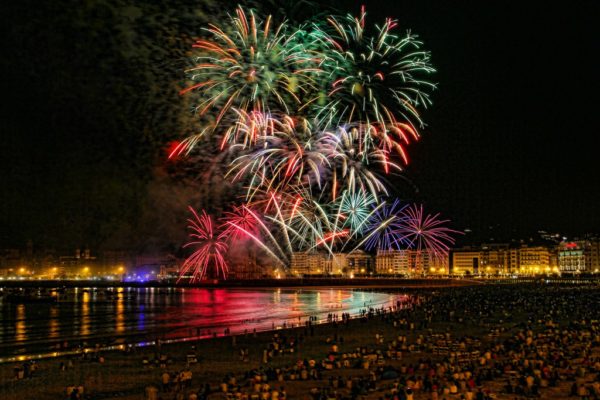 fireworks in the night sky over a body of water